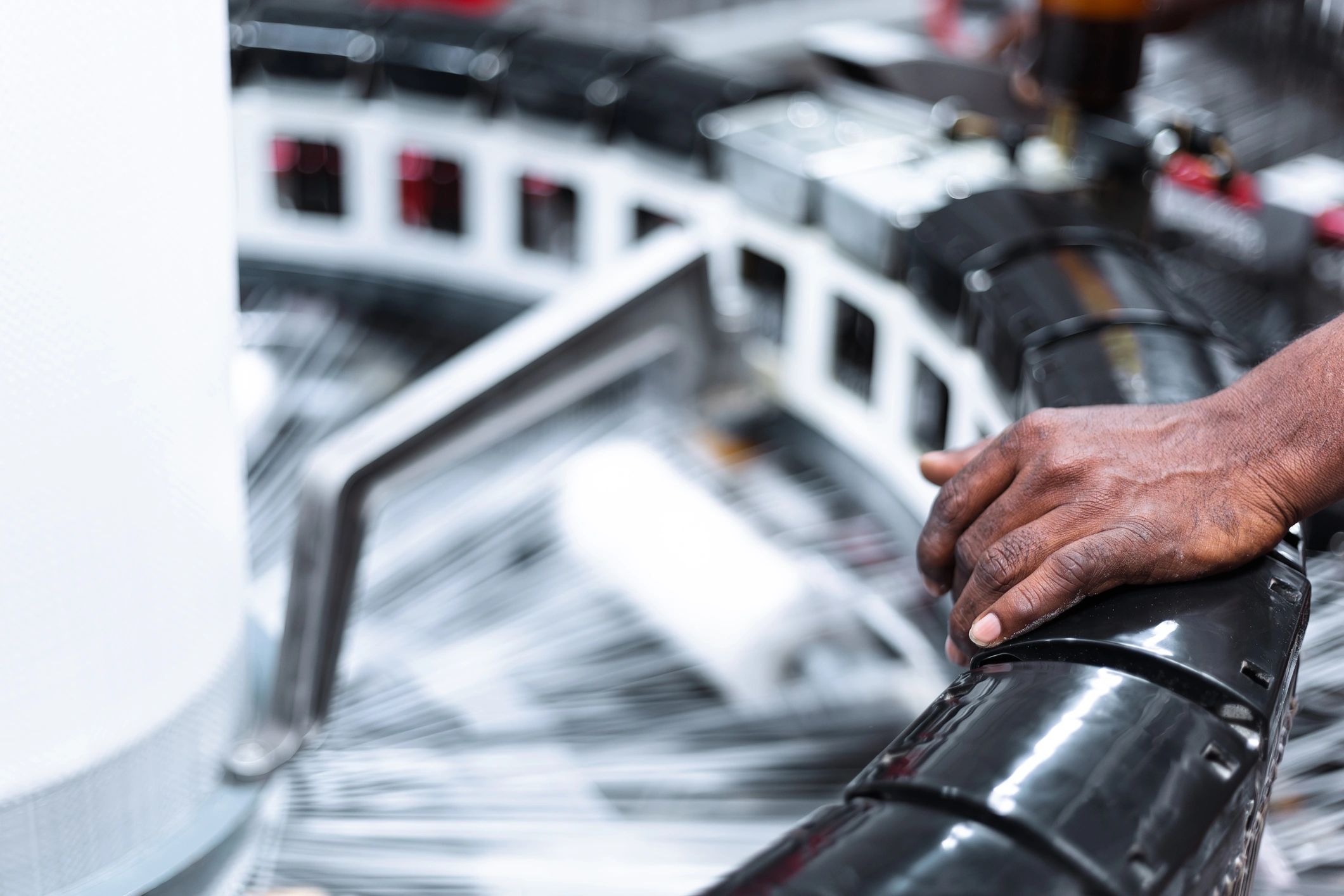 Operator monitoring manufacturing equipment during quality checks